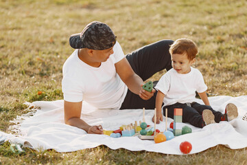 Father and son having fun in summer park