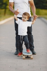 Father and son having fun in summer park