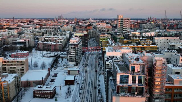 Aerial drone view of traffic on the Valimerenkatu street in Jatkasaari, winter sunset in Helsinki