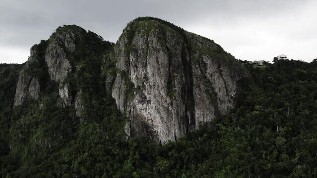 Cerro Las Tetas Puerto Rico Mountains drone push out shot with jungle.
