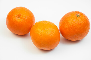 juicy oranges on a white background. sweet big tangerines on the table.orange citrus fruits on a light texture