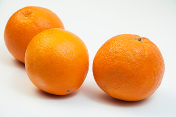 juicy oranges on a white background. sweet big tangerines on the table.orange citrus fruits on a light texture