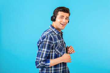 Fototapeta premium stylish young man listening to music on wireless headphones