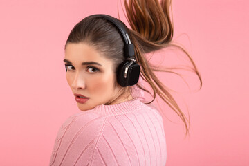 young woman listening to music in headphones