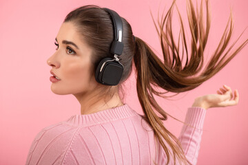 young woman listening to music in headphones