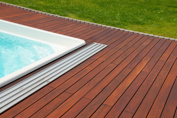 Swimming pool with teakwood flooring stripes summer vacation, teak wood decking
