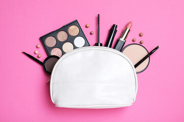 Cosmetic bag with makeup products and accessories on pink background, flat lay