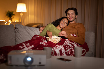 Happy Spouses Hugging Watching Favorite Xmas Films Together At Home