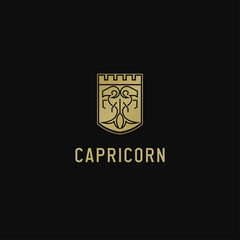 Gold goat vector logo in line art style with crowned shield shape. This is the zodiac sign Capricorn.