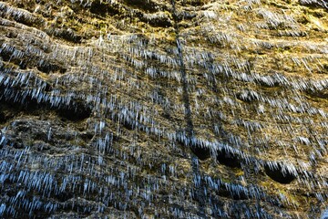Rock wall covered in icicles