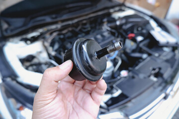 Old gear oil filter of the car transmission system on the mechanic hand