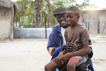 african man with son - obrazy, fototapety, plakaty