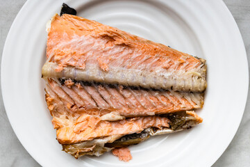 half baked salmon tail part white plate
