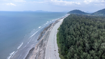 Beautiful black beach with sea wave at Laem Son National park, Ranong, Thailand. The sea beach and the pine trees are halfway in the aerial panoramic view picture.