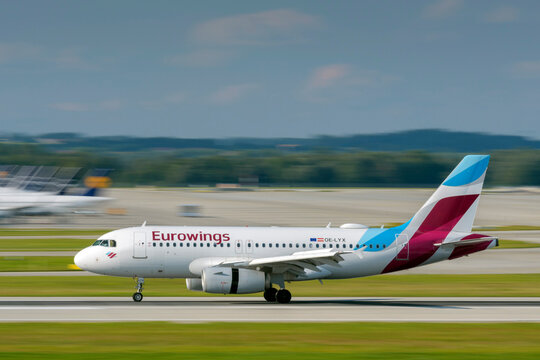 Eurowings Europe Airbus A319-132 with the aircraft registration OE-LYX is landing on the southern runway 26L of the Munich Airport MUC EDDM