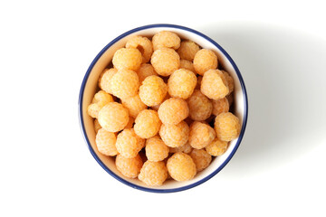 composition of ripe raspberries in a bowl on a textured background