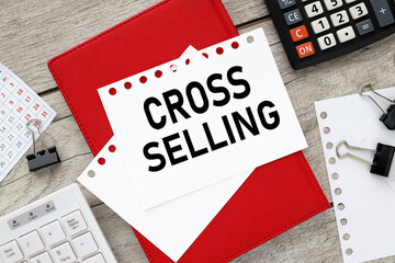 Cross-selling sheets of white paper, pen, keyboard calculator on a wooden background. view from...