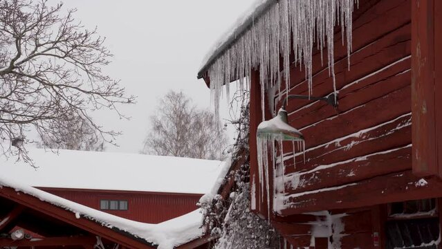 Icicles on the roof of red Cottage 4K