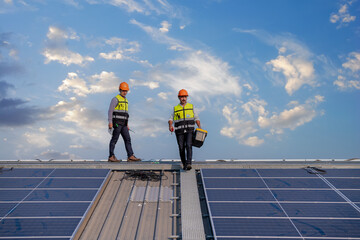 engineers ware uniform working on roof inspect and check solar cell panel equipment box ,drill and...