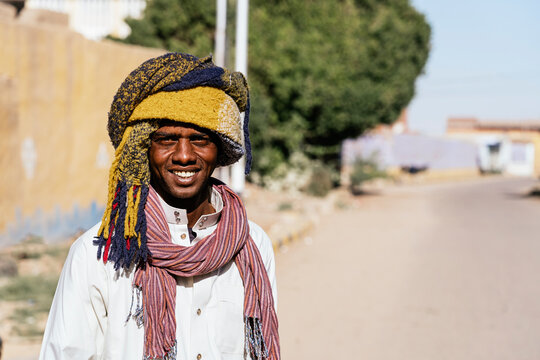 Cheerful Egyptian man in turban in city