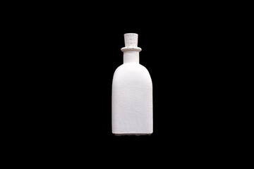 white bottle of gypsum isolated on a black background