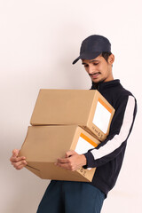 unshaven Indian courier boy with brown box wearing black t-shirt with facial expressions isolated on white background 