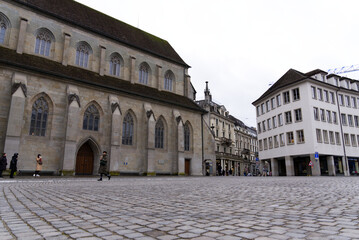 Fototapeta na wymiar Protestant church Women's minster with paving stones at Minster Square in the old town of Zürich at a gray and cloudy winter day. Photo taken February 1st, 2022, Zurich, Switzerland.
