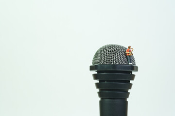 a saxophonist plays the saxophone on a huge microphone, white background, copy space