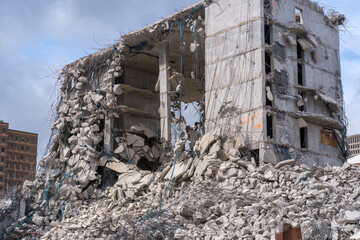 Fototapeta premium Remains and Rubble Pile of Collapsed Building During Final Stages of Demolition