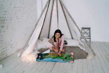 Asian girl looking on Russia map in wigwam tent © BullRun