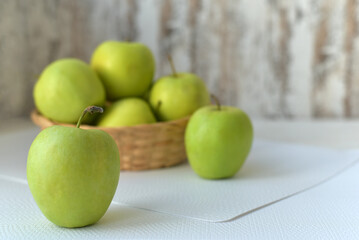 Juicy green apples in a basket