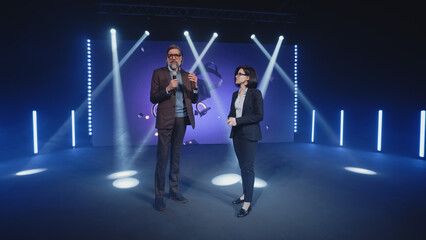 A female presenter interviewing a male developer of a new augmented reality device during the...