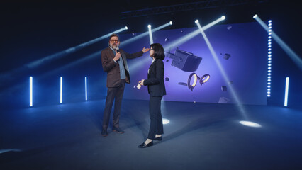 A female presenter interviewing a male developer of a new augmented reality device during the...