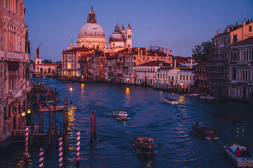 Overview on picturesque landscape in Venice city with motorboat for exploring romantic locations at embankment of Grand Canal, concept of travel voyage vacations for visiting Italian showplaces