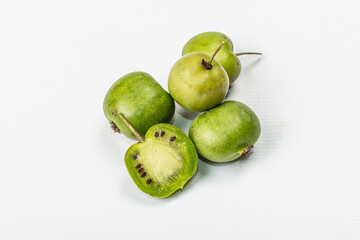 Ripe Actinidia arguta or kiwi isolated on white background