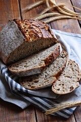 Homemade sourdough bread with seeds on the wooden background