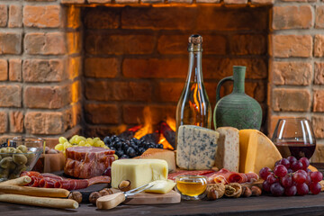 Charcuterie plate board, meat, boiled pork, smoked meats, prosciutto, and wine. Cheese pieces,...