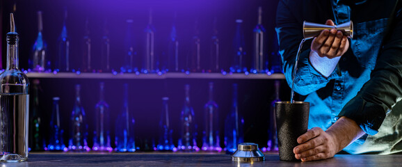 Bartender's hands serving cocktails on bar counter in a restaurant, pub. Mixed drinks. Alcoholic cooler beverage at nightclub on dark background