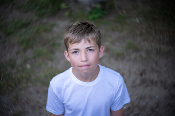 Portrait of a teenager on the background of nature. View from above.