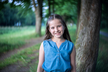 Portrait of a beautiful girl with long hair in nature.