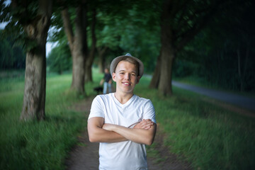 Portrait of a teenager on the background of nature. Natural skin of the face, without retouching.