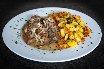 ready to eat - fried potatoes and fried herring on a white plate