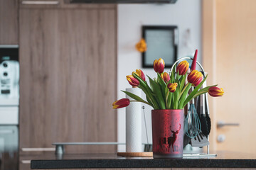 flower vase with colorful tulips on the table in the kitchen