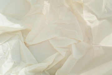 Crumpled craft white paper with hard shadows. Close up background.