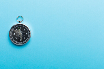 Silver compass on color background. Top view © Liami