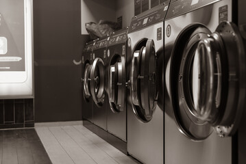 Laundromat inside in the evening, washing machines in a laundromat, black and white photo - Powered by Adobe