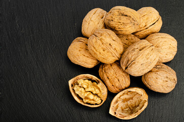 Ripe walnuts on black background. Studio Photo