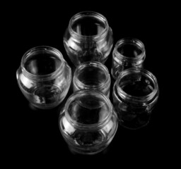 Empty glass jar isolated on black  