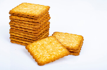 Minimalist pile delicious cookies. Salty biscuit cracker on white background. Studio Photo