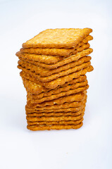 Minimalist pile delicious cookies. Salty biscuit cracker on white background. Studio Photo